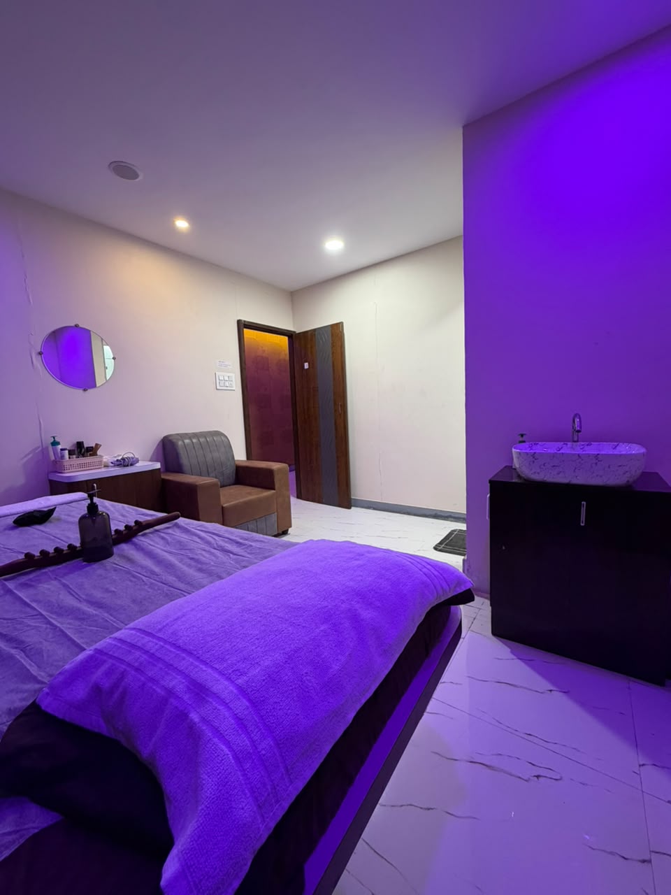 Private chromotherapy suite with Italian Carrara stone flooring at Glow Spa